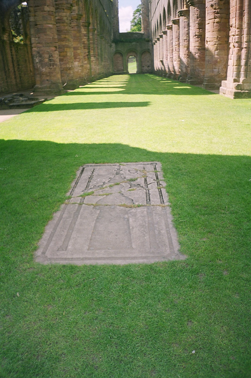 The tombslab of Thomas Swinton, in the nave
              of Fountains Abbey