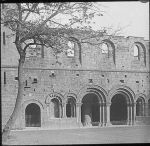 Photograph of Kirkstall Abbey cloister looking east taken after the programme of conservation in 1892-6.